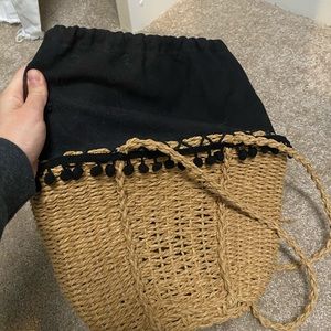 Straw bag with black pompom detail